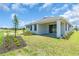 This home features a covered lanai, a well-maintained lawn, and verdant landscaping at 9577 Vibrant Lane, Venice, FL 34292