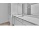 Bathroom with white vanity, quartz countertop, large mirror, shower and tile flooring at 9577 Vibrant Lane, Venice, FL 34292