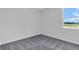 Bedroom with a neutral paint, carpet flooring, natural light from a large window at 9577 Vibrant Lane, Venice, FL 34292
