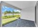 Covered patio with brick pavers and a view of the manicured lawn and landscaping at 9577 Vibrant Lane, Venice, FL 34292