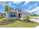 Single-Gathering home featuring a red front door, gray trimmed windows, and low maintenance landscaping at 9577 Vibrant Lane, Venice, FL 34292