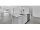 Modern kitchen island with stainless steel dishwasher and sink with modern faucet at 9577 Vibrant Lane, Venice, FL 34292