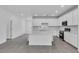 Open kitchen with a large island featuring seating, stainless steel appliances, and ample counter space at 9577 Vibrant Lane, Venice, FL 34292