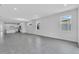 Bright living room featuring an open floor plan, tile floors and natural light from large windows at 9577 Vibrant Lane, Venice, FL 34292