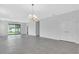 A spacious living room leads to the outside with sliding glass door access to the back yard at 9577 Vibrant Lane, Venice, FL 34292