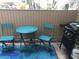 Private patio with a bistro table, chairs, and grill at 705 Bird Bay Cir # 115, Venice, FL 34285