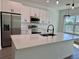 Modern kitchen island with white cabinets, stainless steel appliances, and quartz countertops at 10253 Calumet Blvd, Port Charlotte, FL 33981