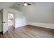 Large bedroom with sloped ceiling, double door closet, and a view to upper floor at 34392 Broken Stone St, Webster, FL 33597