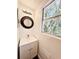Simple bathroom with a vanity, mirror, and window at 34392 Broken Stone St, Webster, FL 33597