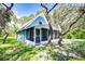 Blue house with screened porch and yard at 34392 Broken Stone St, Webster, FL 33597