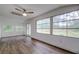 Sunroom with hardwood floors, sliding doors, and multiple windows at 34392 Broken Stone St, Webster, FL 33597
