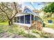 Renovated blue house with a large porch at 34392 Broken Stone St, Webster, FL 33597