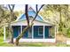 Charming blue house with a screened porch at 34392 Broken Stone St, Webster, FL 33597