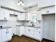 Modern kitchen with white cabinets, granite counters, and tile backsplash at 34392 Broken Stone St, Webster, FL 33597