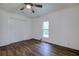 Bedroom with hardwood floors, double closets and ceiling fan at 34392 Broken Stone St, Webster, FL 33597