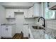 Modern kitchen with white shaker cabinets and granite countertops at 34392 Broken Stone St, Webster, FL 33597