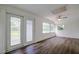 Sunroom with hardwood floors, sliding doors, and multiple windows at 34392 Broken Stone St, Webster, FL 33597