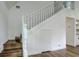White staircase with wood steps and a small storage closet underneath at 34392 Broken Stone St, Webster, FL 33597