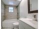 Updated bathroom with a white vanity, tile shower, and decorative mirror at 34392 Broken Stone St, Webster, FL 33597