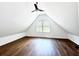Spacious bedroom with a ceiling fan and wood-look flooring at 34392 Broken Stone St, Webster, FL 33597