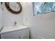 Small bathroom with vanity, toilet and window at 34392 Broken Stone St, Webster, FL 33597