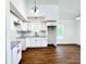 Modern kitchen with white cabinets, granite counters, and tile backsplash at 34392 Broken Stone St, Webster, FL 33597