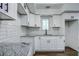 Modern kitchen with white shaker cabinets and granite countertops at 34392 Broken Stone St, Webster, FL 33597