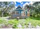 Blue house with a wooden deck and wheelbarrow in front at 34392 Broken Stone St, Webster, FL 33597