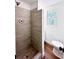 Modern bathroom with a walk-in shower, toilet and wood-look flooring at 34392 Broken Stone St, Webster, FL 33597