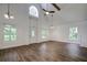 High-ceilinged living room with hardwood floors and lots of natural light at 34392 Broken Stone St, Webster, FL 33597