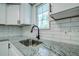 Modern kitchen with white shaker cabinets and granite countertops at 34392 Broken Stone St, Webster, FL 33597