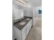 Modern bathroom featuring double sinks with granite countertops and white cabinetry with an entrance to the main bedroom at 33083 Windelstraw Dr, Wesley Chapel, FL 33545