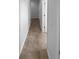Hallway featuring tile flooring and access to multiple rooms at 33083 Windelstraw Dr, Wesley Chapel, FL 33545