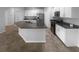 Spacious kitchen featuring granite countertops, an island, and modern black appliances at 33083 Windelstraw Dr, Wesley Chapel, FL 33545