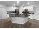 Open kitchen with granite countertops, stainless steel appliances, and ample cabinet space at 33083 Windelstraw Dr, Wesley Chapel, FL 33545