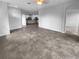 Spacious living room with tile floors flows into the kitchen, perfect for entertaining and relaxation at 33083 Windelstraw Dr, Wesley Chapel, FL 33545