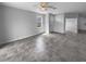 Open living area with tile floors, ceiling fan, and abundant natural light from large window at 33083 Windelstraw Dr, Wesley Chapel, FL 33545