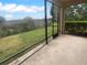Screened-in patio offering views of the backyard and surrounding landscape at 33083 Windelstraw Dr, Wesley Chapel, FL 33545
