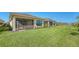 Large backyard with grassy lawn and screened patio at 4915 Carova Way, Lakewood Ranch, FL 34211