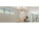 Modern kitchen features white cabinets, stainless steel appliances, and elegant chandelier at 4915 Carova Way, Lakewood Ranch, FL 34211