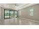 Bright living room with sliding glass doors and tile floors at 4915 Carova Way, Lakewood Ranch, FL 34211