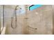 Walk-in shower with neutral tile and built-in shelving at 4915 Carova Way, Lakewood Ranch, FL 34211
