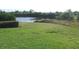 Expansive backyard with green grass, potential landscaping, and a serene view of the pond at 11774 Tempest Harbor Loop, Venice, FL 34292