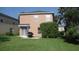 Green backyard with a covered patio area perfect for outdoor dining and relaxing at 11774 Tempest Harbor Loop, Venice, FL 34292
