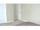 Bright bedroom with neutral walls, plush carpeting, and white doors, ready for personalization at 11774 Tempest Harbor Loop, Venice, FL 34292