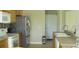 Kitchen features stainless steel appliances, tile backsplash, and wooden cabinets at 11774 Tempest Harbor Loop, Venice, FL 34292