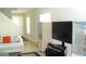 A view of a living room area with a sofa, TV, storage, and an outside view from the windows at 11774 Tempest Harbor Loop, Venice, FL 34292
