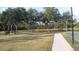 Community park with trees, benches, tennis court, and recreation area for outdoor enjoyment at 11774 Tempest Harbor Loop, Venice, FL 34292