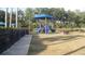 Community playground area featuring a blue playset with slide, covered picnic area, and greenery at 11774 Tempest Harbor Loop, Venice, FL 34292