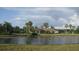 A community clubhouse situated behind a picturesque pond and lush landscaping at 11774 Tempest Harbor Loop, Venice, FL 34292